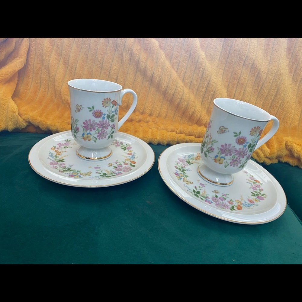 Two sets of mugs with saucers